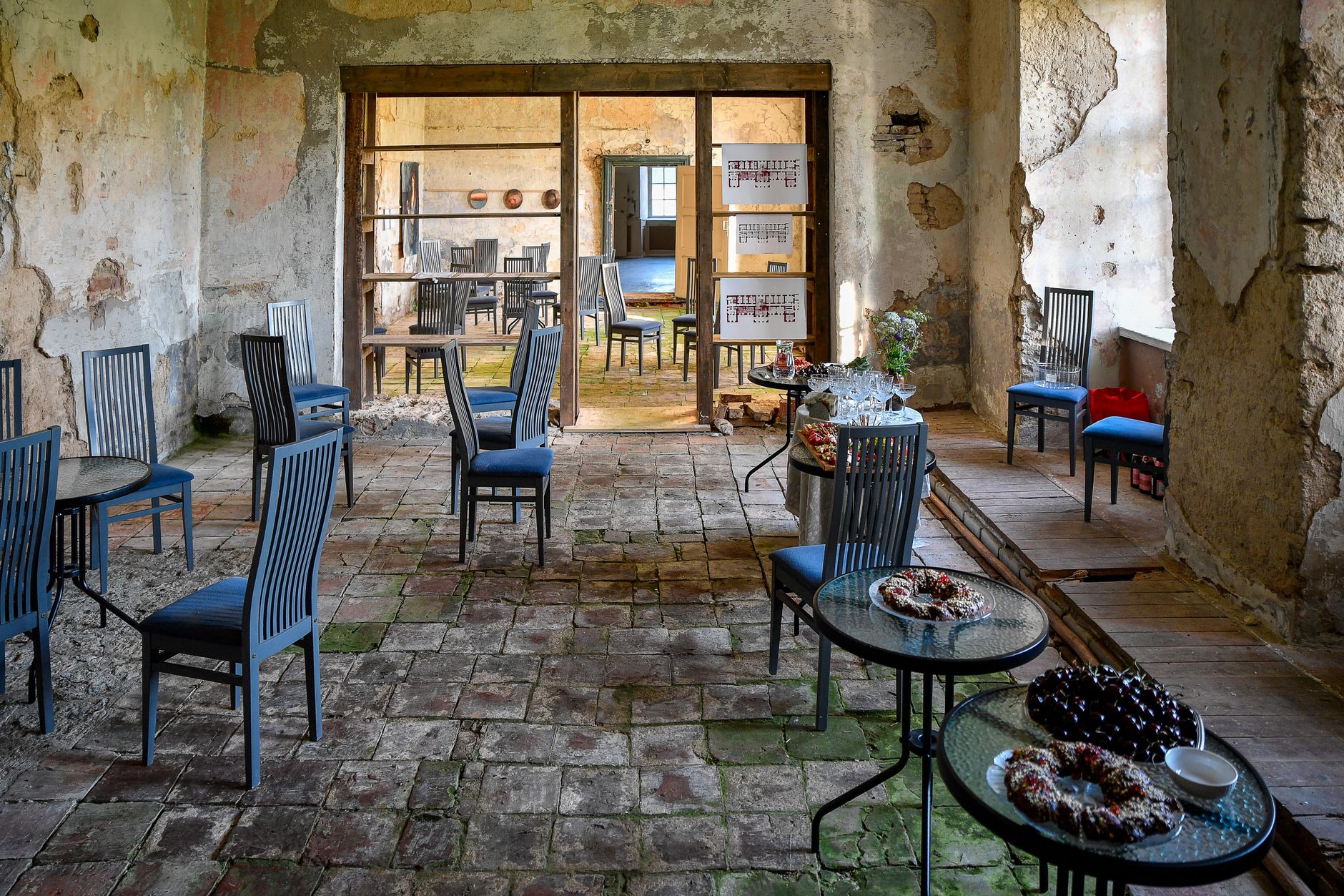 An empty rustic venue in Kolga, Estonia, with weathered walls and scattered seating creating a historic atmosphere.