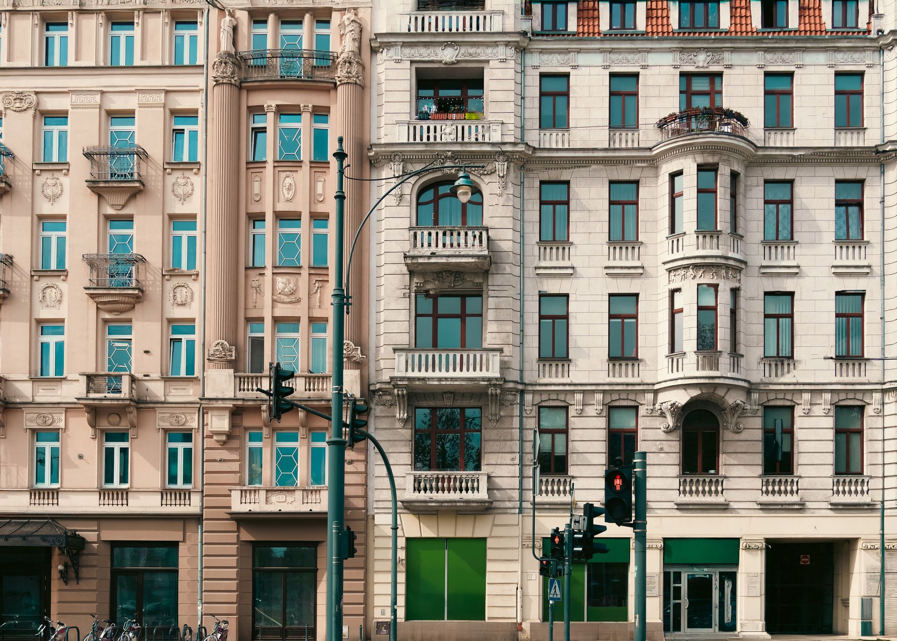 Ornate historic building facades on a city street in Łódź, Poland. Architectural detail and urban charm.