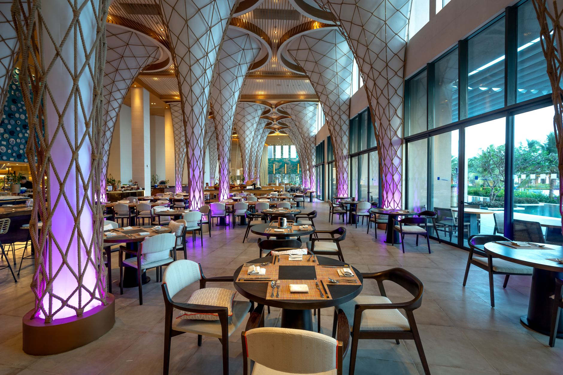 Spacious modern restaurant interior with unique architectural design and ambient lighting.