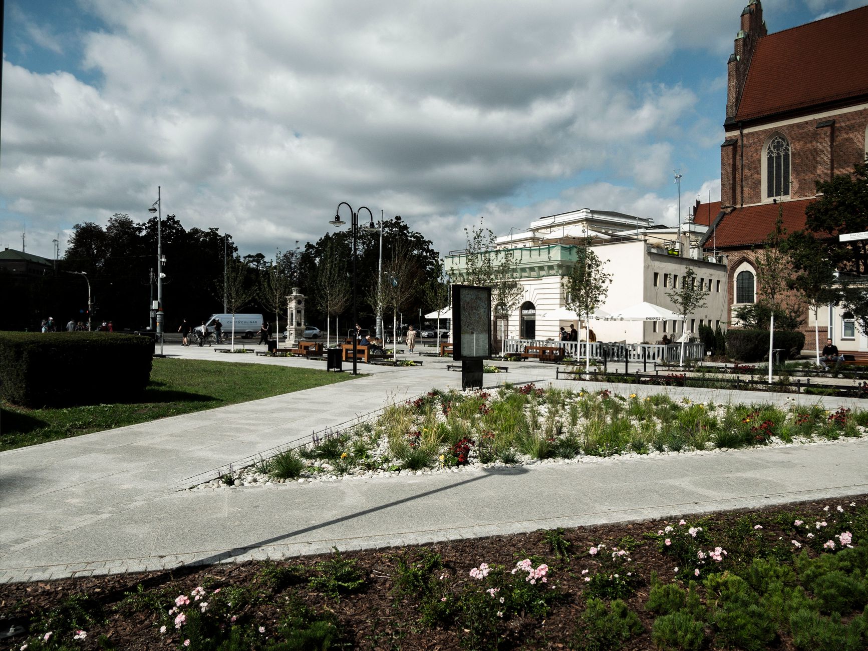 Explore the serene city park in Wrocław featuring historical architecture and beautiful gardens.