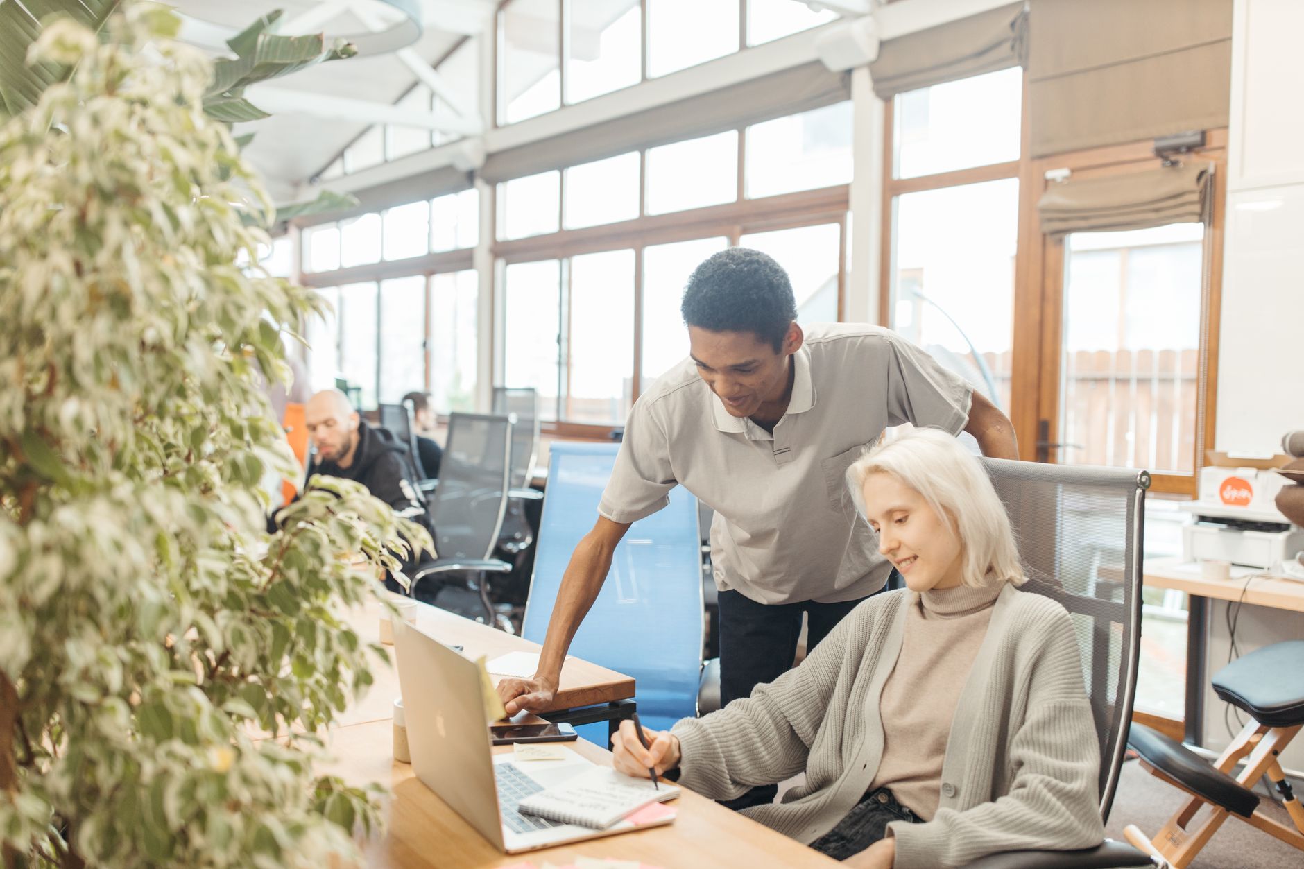 A diverse team working together in a modern office space, showcasing teamwork and collaboration.