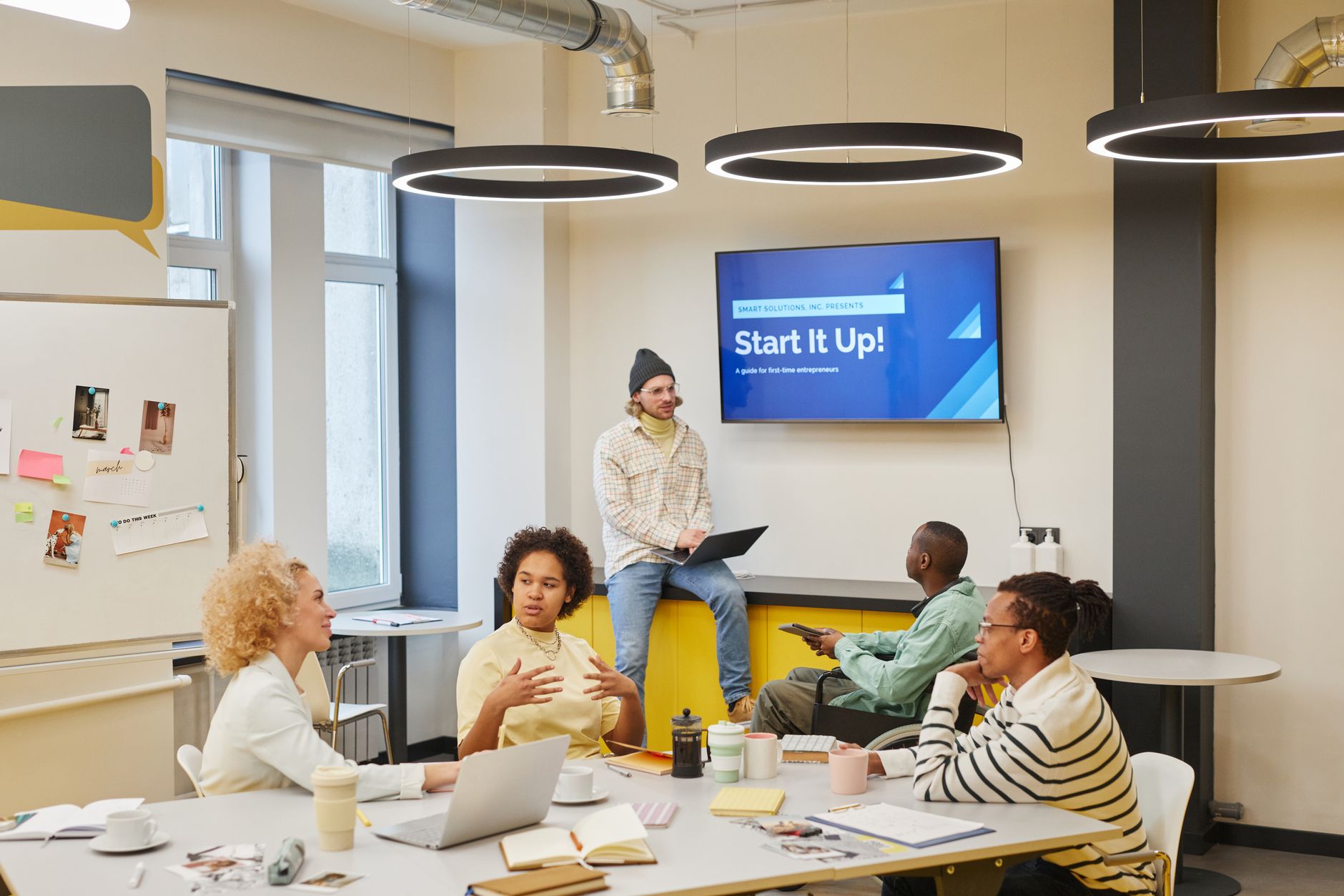 Diverse group discussing startup ideas in a creative office environment.