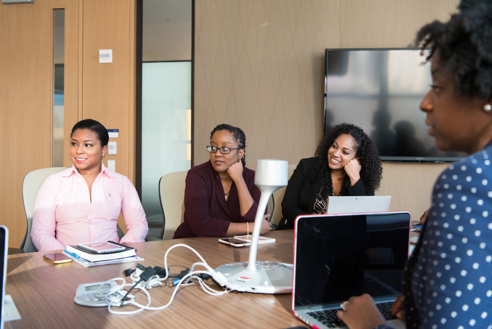 Group of women engaging in a collaborative meeting in a modern office setting.
