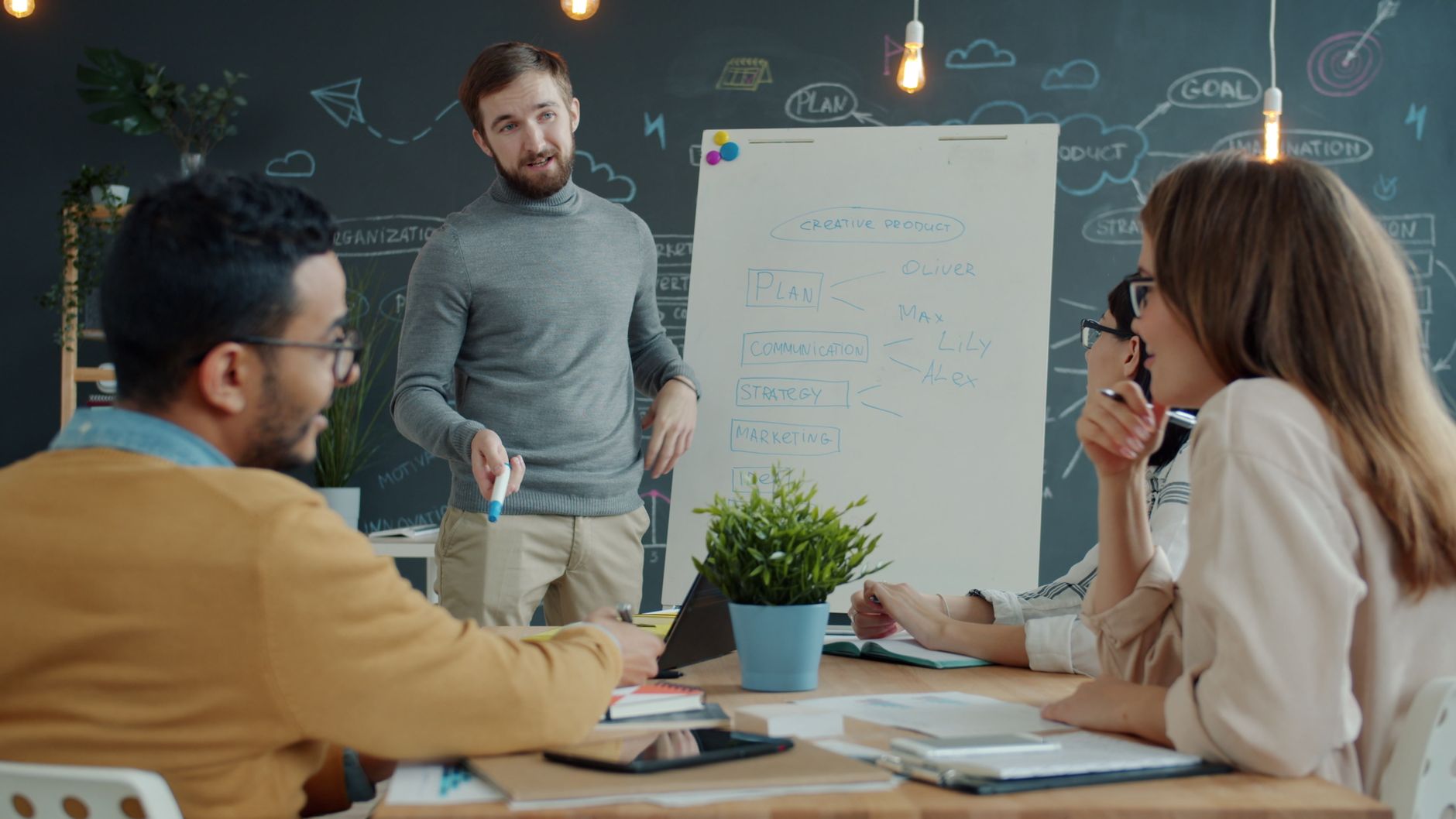 A collaborative team meeting with a presentation on strategy and marketing plans.