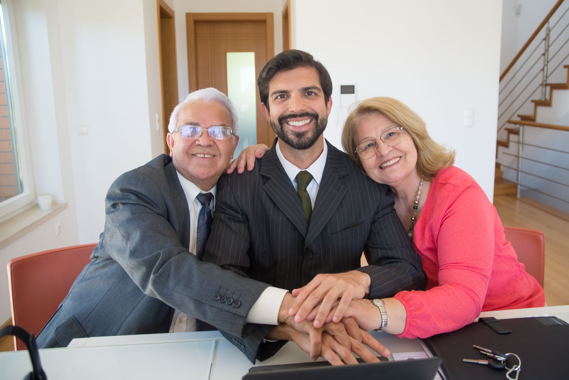 A joyful family embracing around a desk, symbolizing support and teamwork.